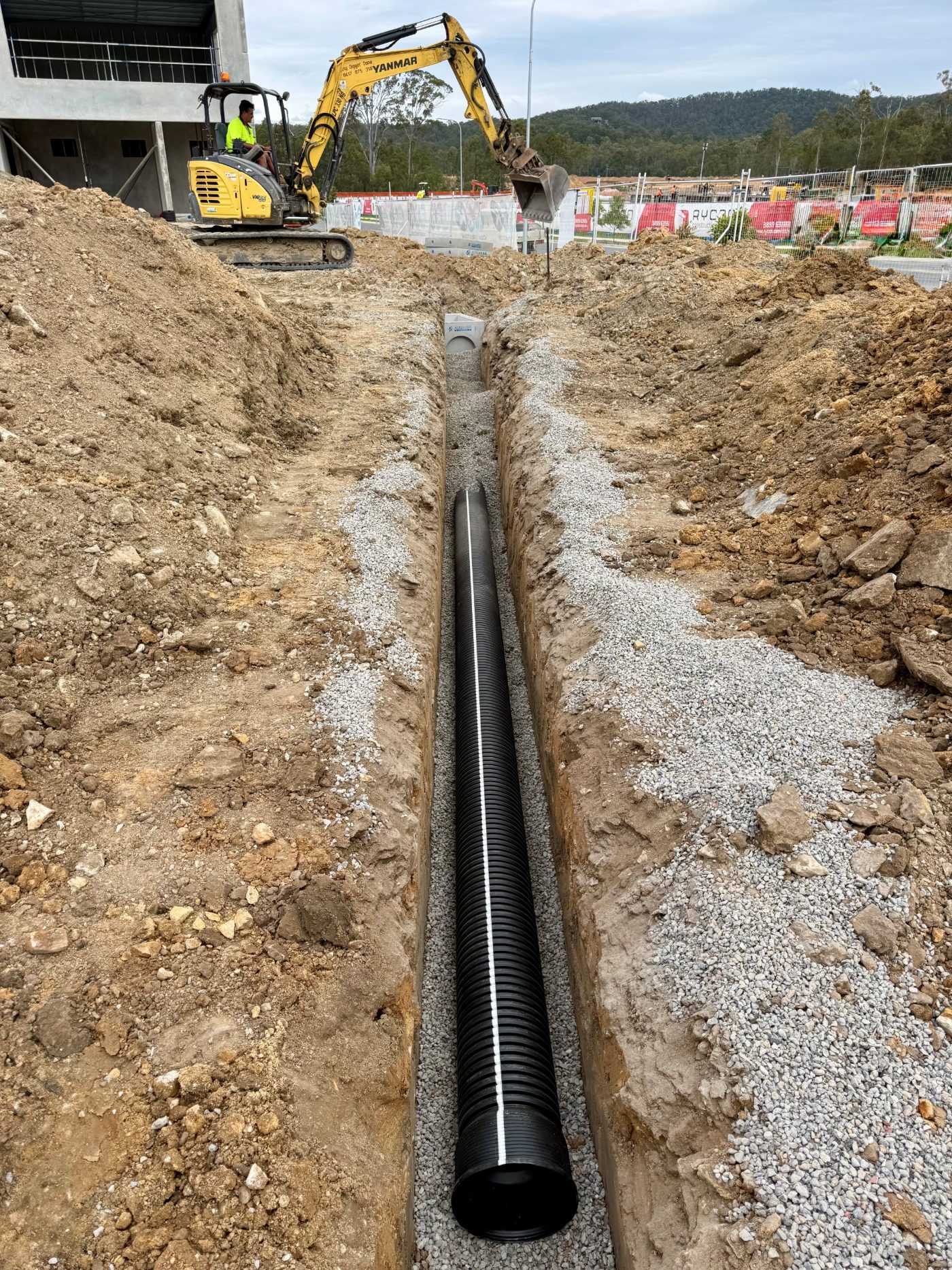 Stormwater drainage line bedded in gravel on a commercial site in South East Queensland