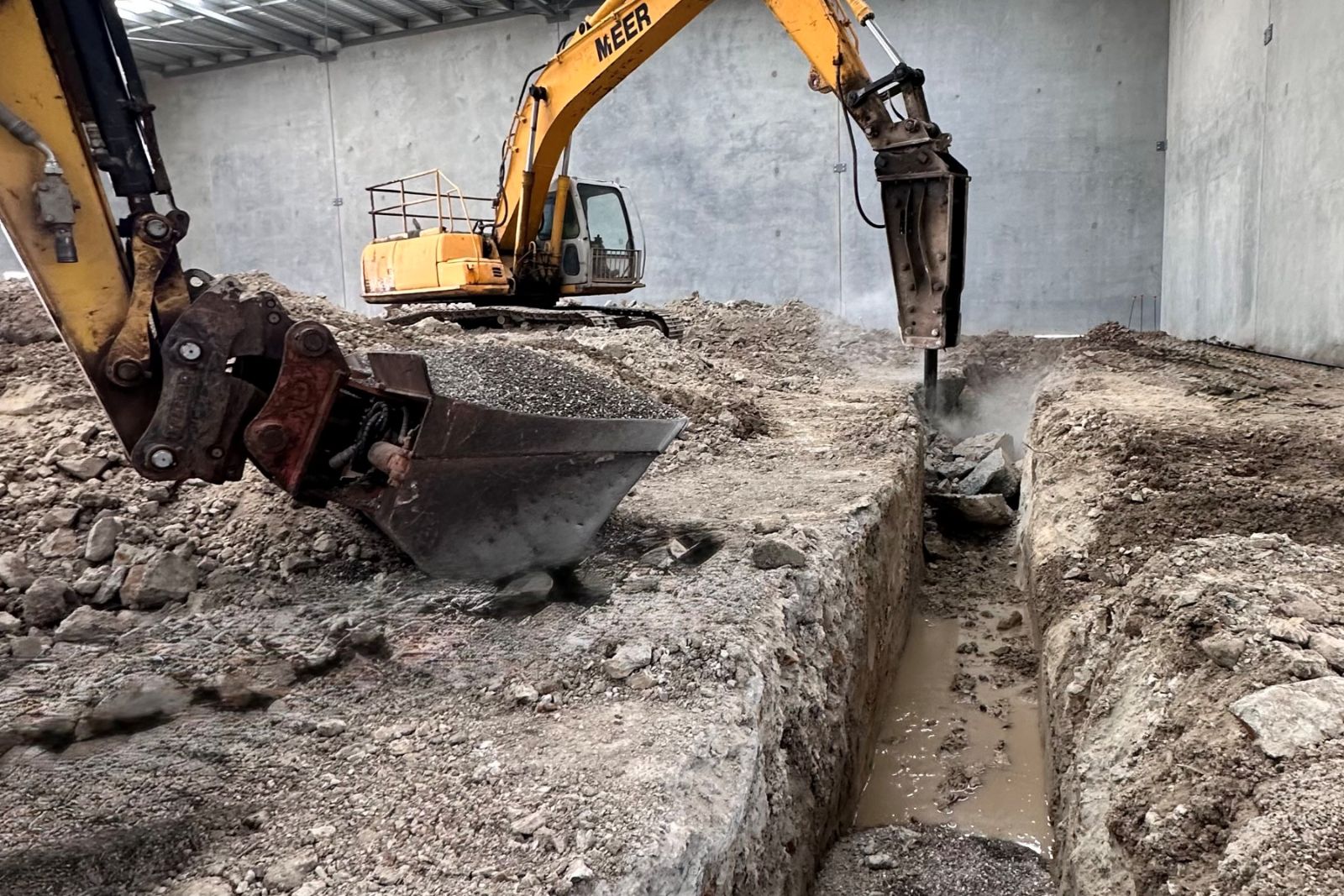 Rock breaking and drainage excavation inside a commercial building